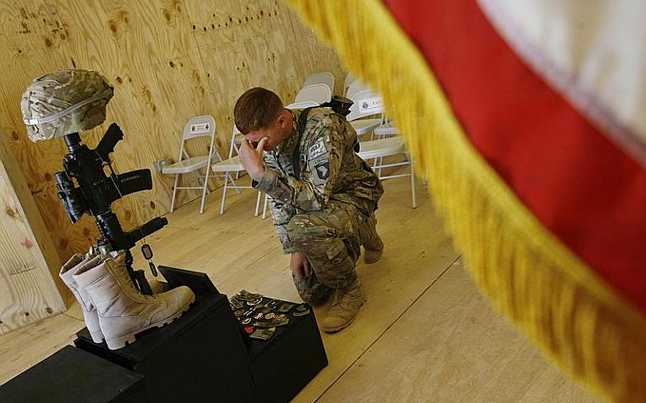 Spc. Matthew Woodall of Company E, 2nd Battalion, 506th Infantry Regiment, 4th Brigade Combat Team, 101st Airborne Division, pauses after a memorial service for Pfc. Anthony Nunn, 19, at Forward Operating Base Zerok in Paktika province, Afghanistan, on June 2, 2011. 