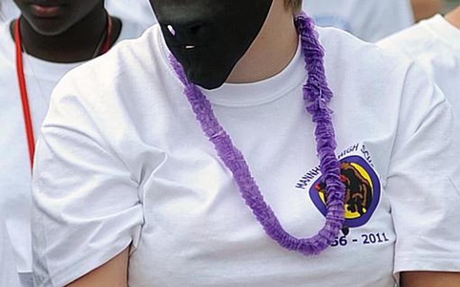 Corina Goers, a Mannheim High School freshman, wears a Bison mask following a drama club performance at the school's closing ceremony on Thursday.