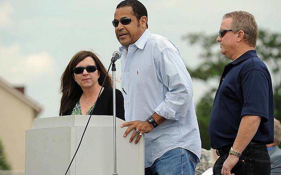 Mannheim High School alumni Kelly McMillan, left, and Gene Moats, right, listen as Wendell Burden talks about going to school at Mannheim during a closing ceremony for the high school and middle school on Thursday. McMillan was in the class of '79, Moats and Burden in the class of '77.