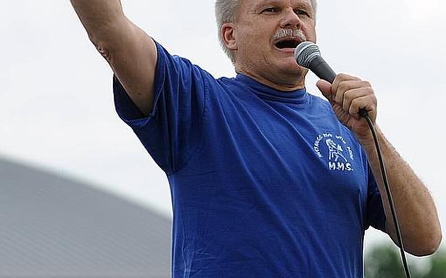 Heidelberg District superintendent Frank Roehl, a former Mannheim Middle School principal, leads the students through one last Mustang cheer during a ceremony marking the closing of the middle school and high school on Thursday.