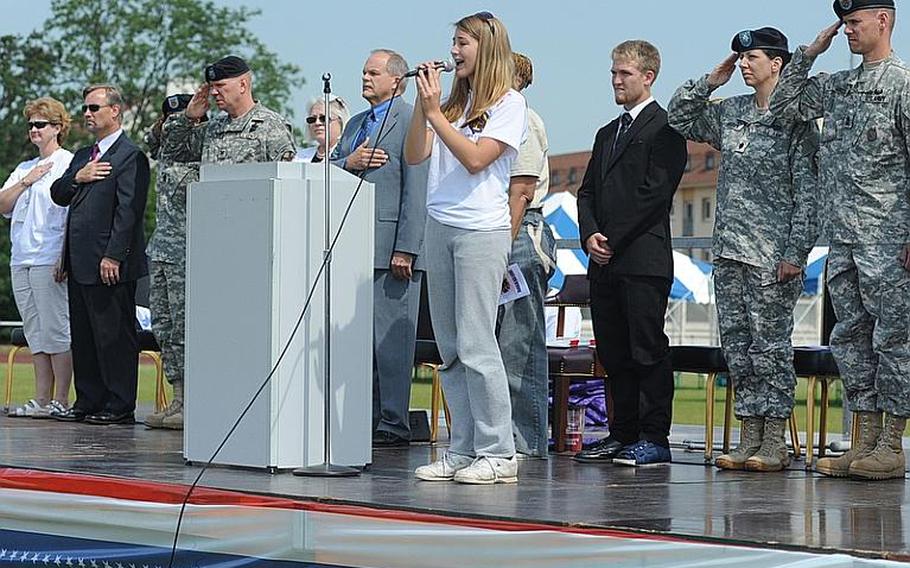 Mannheim High School student Kaitlin Laws sings the national anthem at the "Moving On" celebration Thursday marking the closing of the high school and middle school.