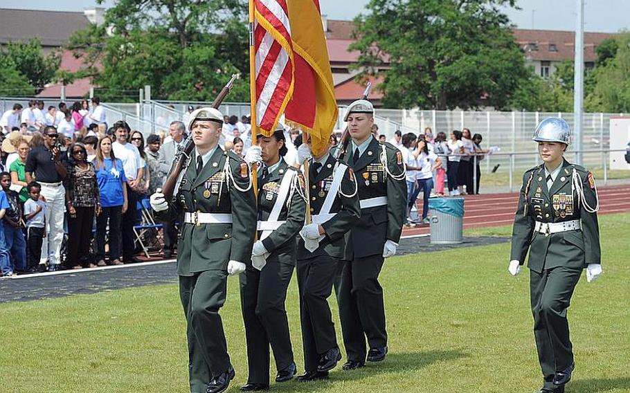 The Mannheim High School Junior ROTC color guard marches off Woods Memorial Field for the last time at a closing ceremony for the school and the middle school on Thursday.