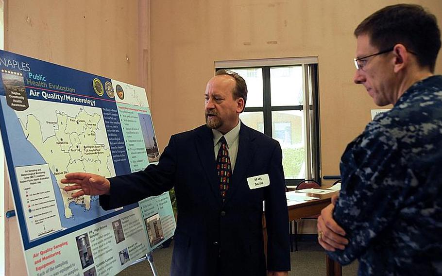 Matthew Soltis, vice president of the environmental company Tetra Tech and a project manager for the Naples Public Health Evaluation, explains results of a year-long air monitoring study his company performed to determine if Naples' air quality posed a health risk to Naples families to Lt. Cmdr. Rick Larson, a base official attending an open house on the review. 