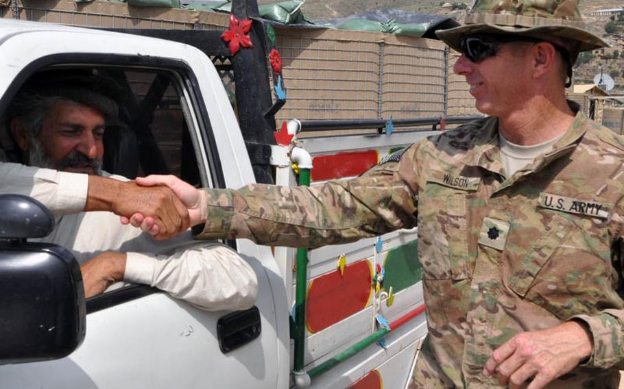 Lt. Col. Dan Wilson, commander of Task Force No Fear based at Forward Operating Base Bostick in eastern Afghanistan, bids farewell on Friday to Musafir Khan Qayumzai, the governor of Ghaziabad district in Kunar province, who spent time at the base to recover from a gunshot wound after regaining his freedom from kidnappers last week.