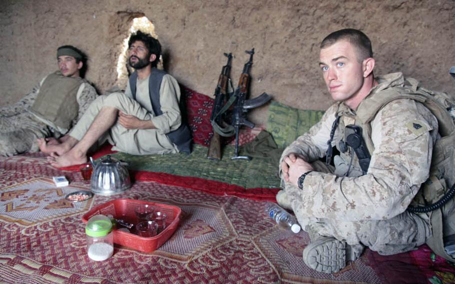 Sgt. Donald Hickman Jr., a squad leader in Company G&#39;s 3rd Platoon, listens to a member of a local Afghan defense force known as the ISCI, or Interim Security for Critical Infrastructure, during a meeting with the force&#39;s commander, Rafiullah, center. Rafiullah is a close relative of one of the area&#39;s tribal elder. Company G is part of 2nd Battalion, 8th Marine Regiment.