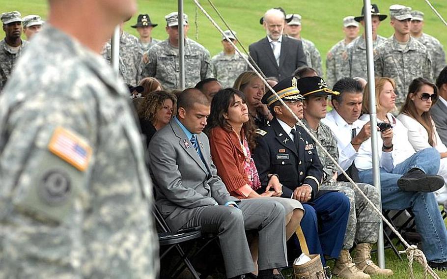 Chris Valadez, 26, left, bows his head during a memorial ceremony in Vilseck on Friday for soldiers killed during the recent deployment of the 2nd Stryker Cavalry Regiment to Afghanistan. Valadez' brother, Pfc. John Andrade was killed Aug. 7, 2010, when his vehicle struck a roadside bomb in Kandahar Province. 

Steven Beardsley/Stars and Stripes