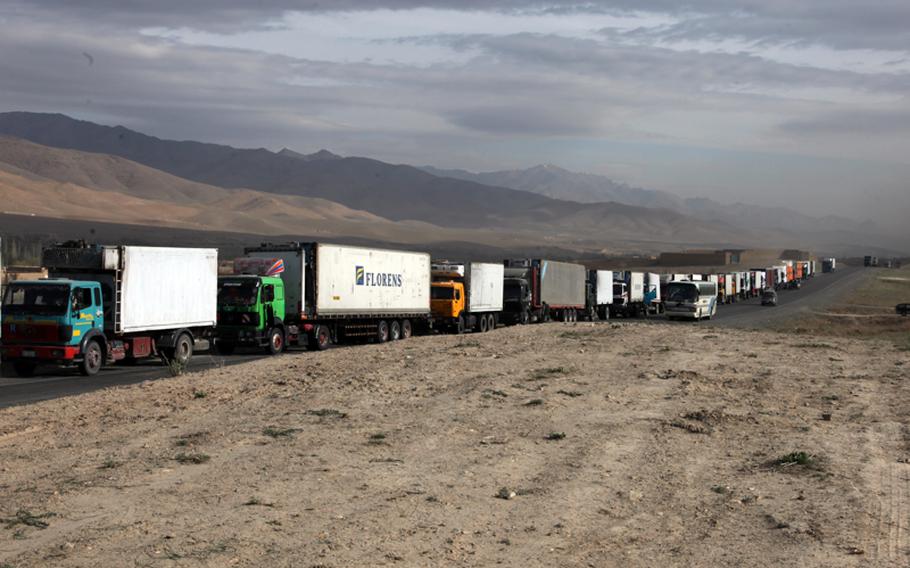 A convoy of trucks driven by Afghans wait on Highway 1 for the U.S. military to clear the dangerous stretch of road ahead of any possible improvised explosive devices and enemy fighters in Sayed-Abad district, Wardak province, Afghanistan, in 2010. Often, there are no good options to be decided on as the trucks themselves become potential targets while waiting.