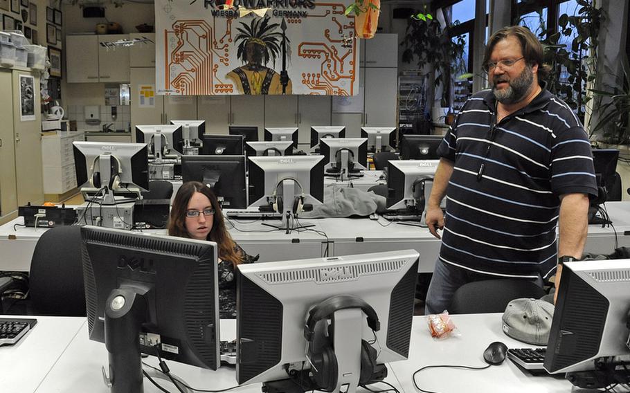 Frank Pendzich talks to Casey Mann as they look over the design for Wiesbaden High School's robot that was entered in the FIRST Robotics Competition in Las Vegas last school year. DODEA is launching a pilot program this year focusing on the STEM (science, technology, engineering and math) initiative, and robotics engineering is one of the classes being offered at a few DODEA schools.