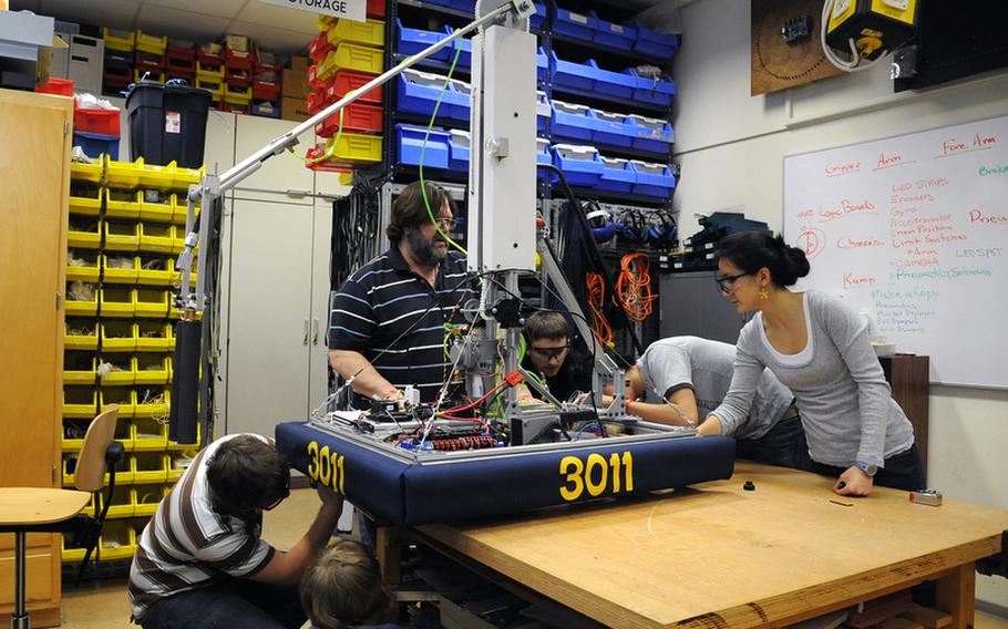 Last February Wiesbaden robotics club adviser Frank Pendzich, center, watched as Tim Kanser, Riley Pickering, Kenny Philips, Dhillon Tisdale and Shena Cousens, from left, attached skirting to the RoboWarriors' robot as they got it ready to be shipped off to Las Vegas for the  FIRST Robotics Competition. DODEA is launching a pilot program at a handful of DODEA schools this year focusing on the STEM (science, technology, engineering and math) initiatives, and robotics engineering is one of the classes.