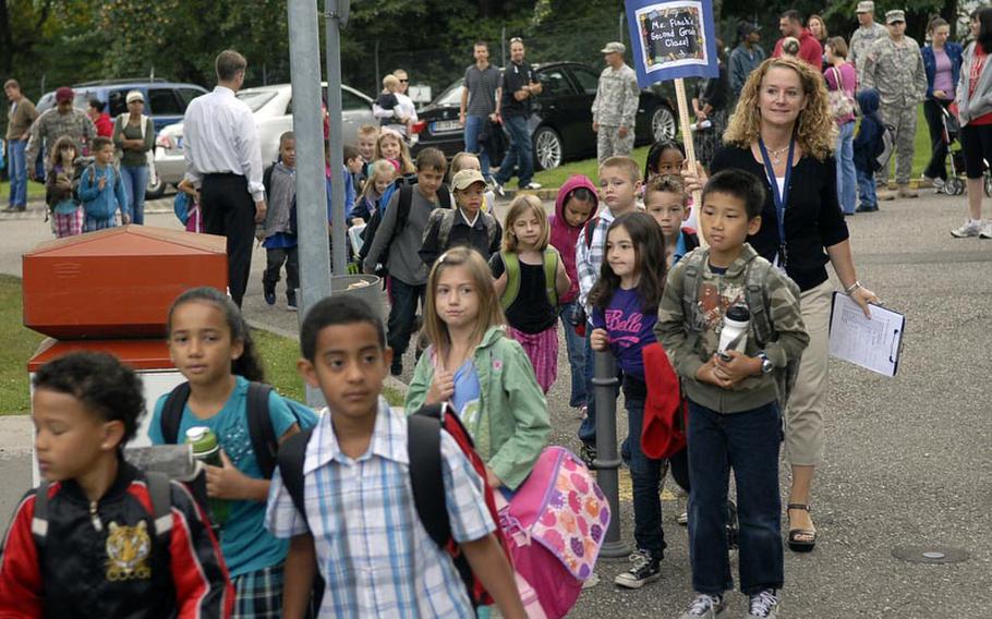 Parents watch as teachers at Robinson Elementary/Middle School lead their students to the classrooms on the first day of school Aug. 29 at Robinson Barracks in Stuttgart, Germany.