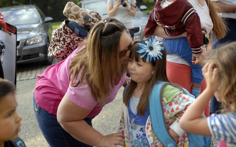 Chassity Beisner gives a farewell-kiss to her daughter, Alyssa Beisner, a first-grader at Robinson Elementary/Middle School, on the first day of school Aug. 29 at Robinson Barracks in Stuttgart, Germany.