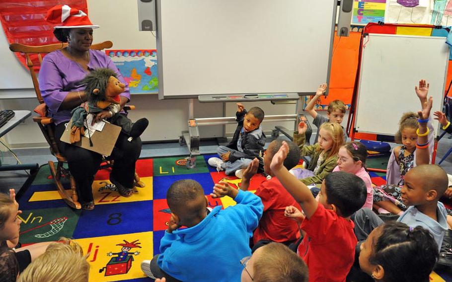 Pupils at Mannheim Elementary School raise their hands to get the chance to answer a question in Maxie Egele&#39;s second grade class, on the first day of school  Monday. It is the final year for the elementary school, as the Mannheim military community closes down.