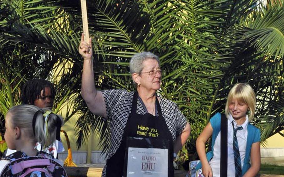 Mary Beth Hail, a third grade teacher at Naples Elementary School in Italy, attempts to corral her new students Monday morning.