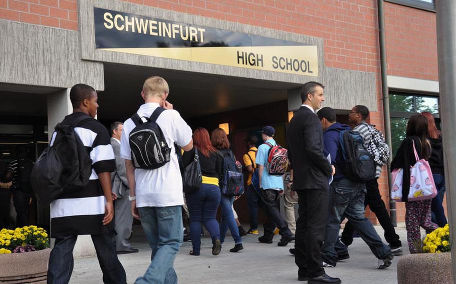 Students are greeted by school administrators and garrison officials on the first day of school at the new Schweinfurt High School.