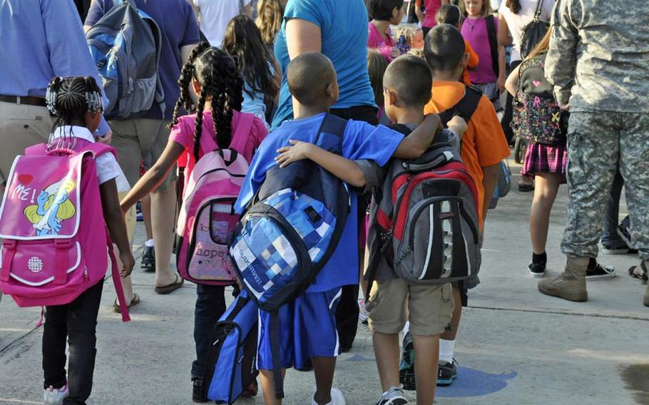 Two buddies make their way to class Monday in Naples, Italy. Students at Defense Department schools around the world head back to class this week.