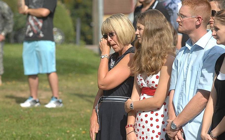 Jana Rustler, 50, left, and her daughter, Anna Rustler, 14, react during a 9/11 memorial ceremony held Sunday at Rose Barracks in Vilseck. The ceremony oversaw the transfer of a steel beam from the World Trade Center to the nearby town of Oberviechtach, where a memorial to the attacks is being planned.