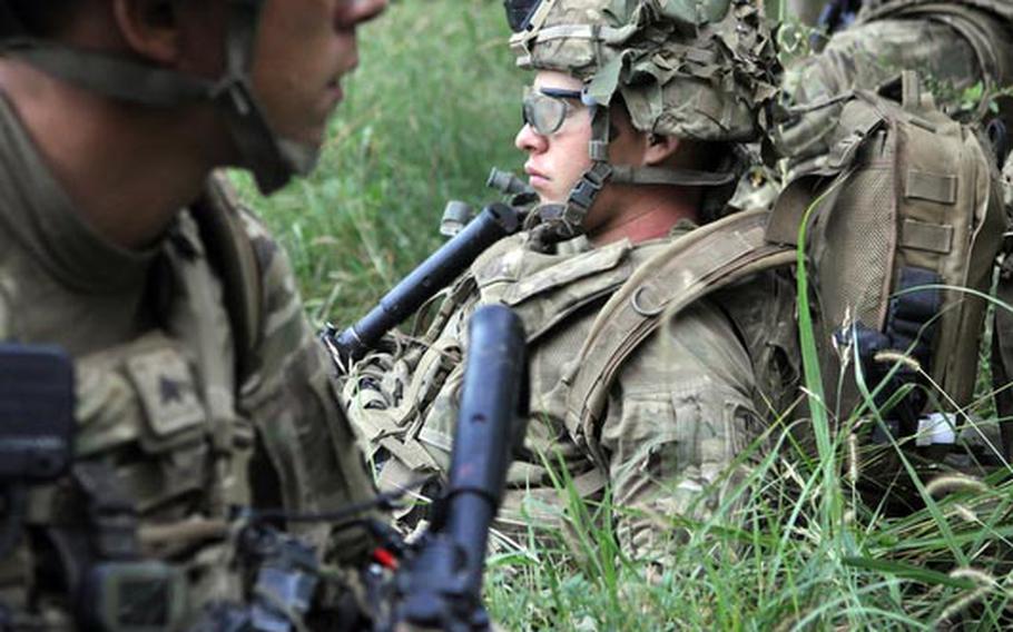 Soldiers of 3rd Platoon, Destroyer Company, 2nd Battalion of the 87th Infantry Regiment, take a break while searching a pomegranate orchard near the Arghandab River.