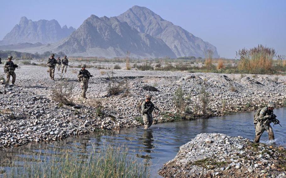 Soldiers of 3rd Platoon, Destroyer Company, 2nd Battalion of the 87th Infantry Regiment, wade through a braid of the Arghandab River after a night raid in southern Kandahar.