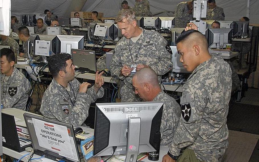 U.S. Soldiers confer in November 2011 in one of the operations centers utilized during Warpath III - an exercise during which about 1,000 American and South Korean soldiers practiced how they would respond to a chemical or biological attack by North Korea.   