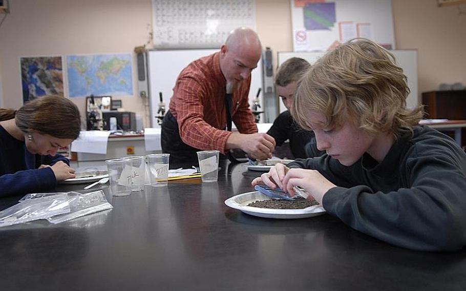 Michael Neisner, 11, sifts through dirt in teacher Tom Oliver's science class at Bitburg Middle School. Oliver's fifth and sixth graders are participating in the Mastodon Matrix Project, helping researchers in the states examine sediment unearthed from a mastodon excavation site in New York. The project is part of an effort by Defense Department schools to encourage student interest and learning in science and math.