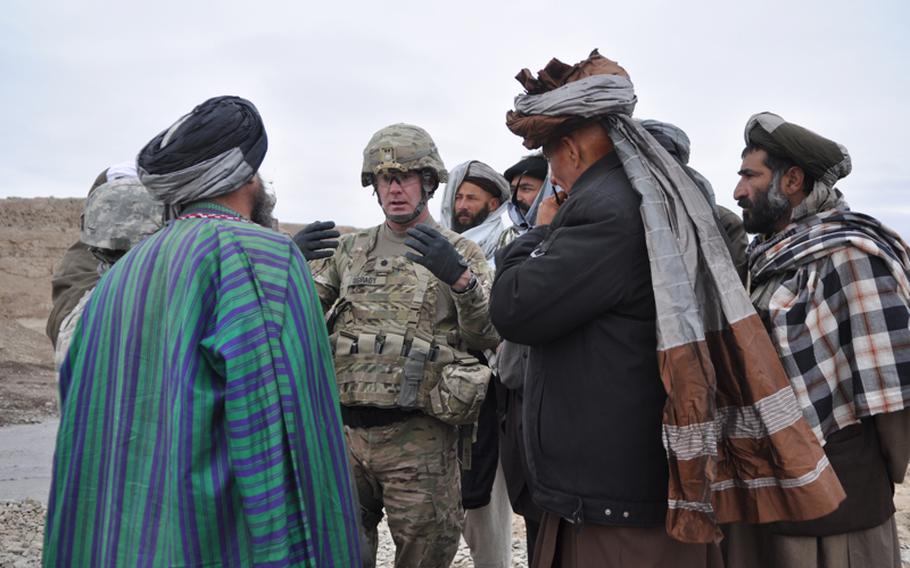 Lt. Col. John O&#39;Grady, commander of 1st Battalion, 84th Field Artillery Regiment, speaks with elders at the opening of a new river crossing near the town of Gormach in western Faryab province.