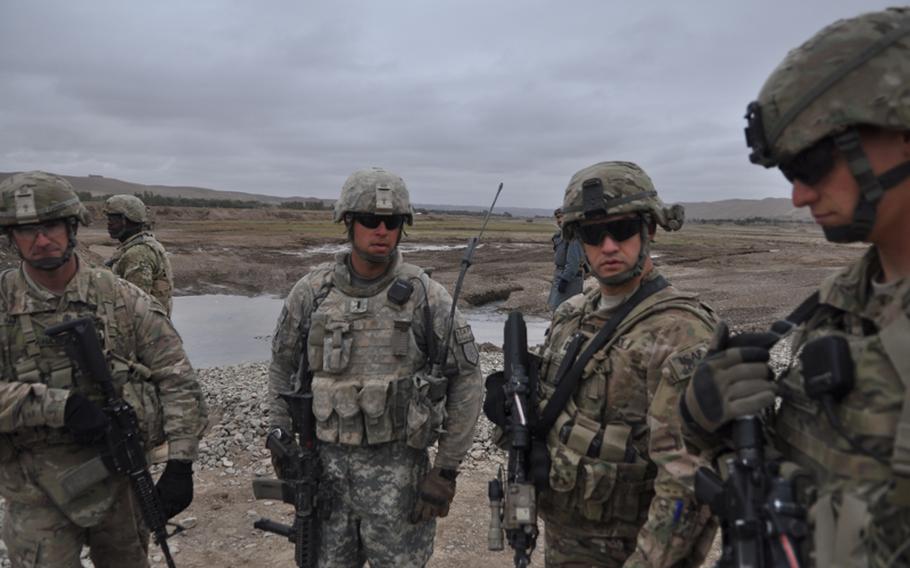 Capt. Timothy McCarthy second from right, commander of Charlie Battery, 1st Battalion, 84th Field Artillery Regiment, near the town of Gormach in western Faryab province. "When you get a friend in this area, you gotta latch on with both hands," he said.