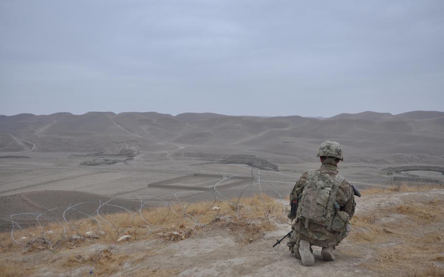 At a hilltop outpost, American artilleryman looks out over a broad, empty plain in western Faryab. "This is where ISAF ends," an American officer said.