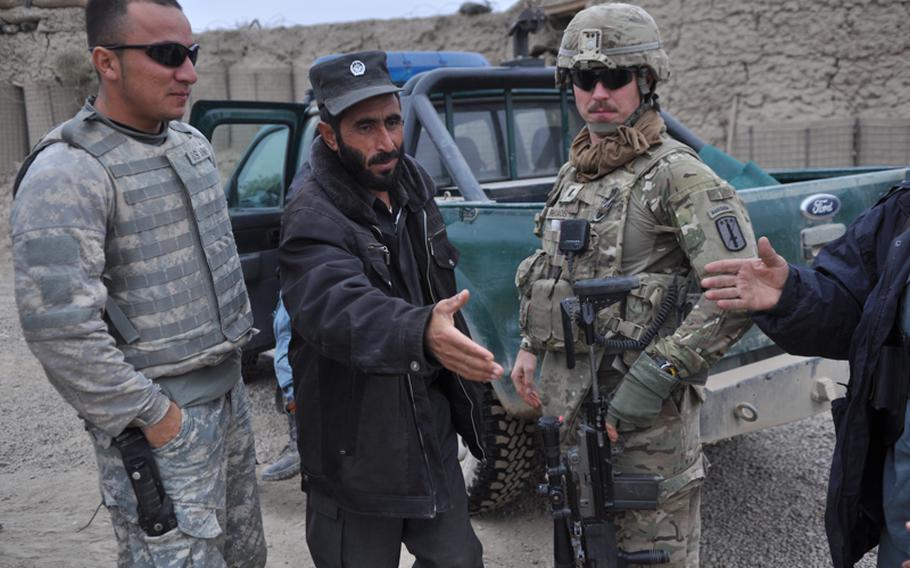 First Lt. Alexander Rhoads, leader of 3rd Platoon, Charlie Battery, 1-84 Field Artillery Battalion, greets Afghan National Policemen at a checkpoint near the village of Gormach. "Some of these guys are good and they&#39;ll go out on patrols," Rhoads said. "Some of them never leave their little outposts."