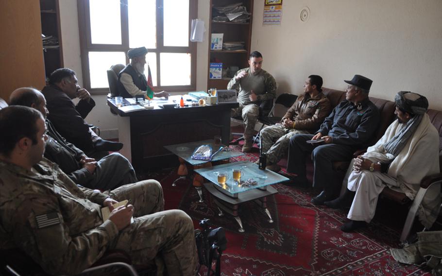 Capt. Timothy McCarthy, center, commander of Charlie Battery, 1-84 Field Artillery Battalion, talks with Afghan government officials at the district center in Gormach, western Faryab province. "This place has been described as an economy of force within and economy of force," McCarthy said. "We are on the fringe."