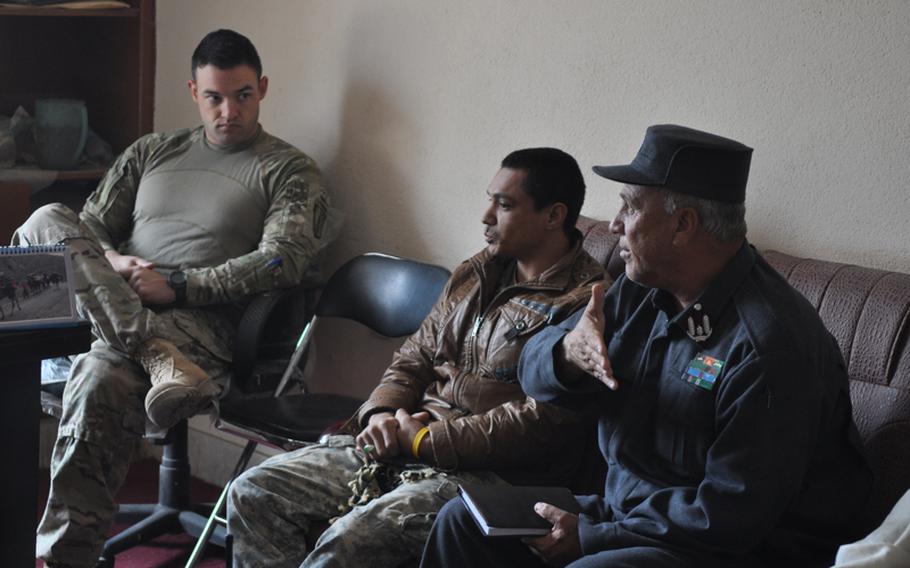 Capt. Timothy McCarthy, left, commander of Charlie Battery, 1-84 Field Artillery Battalion, listens as an Afghan police commander discusses security problems in Gormach, western Faryab province, in November.