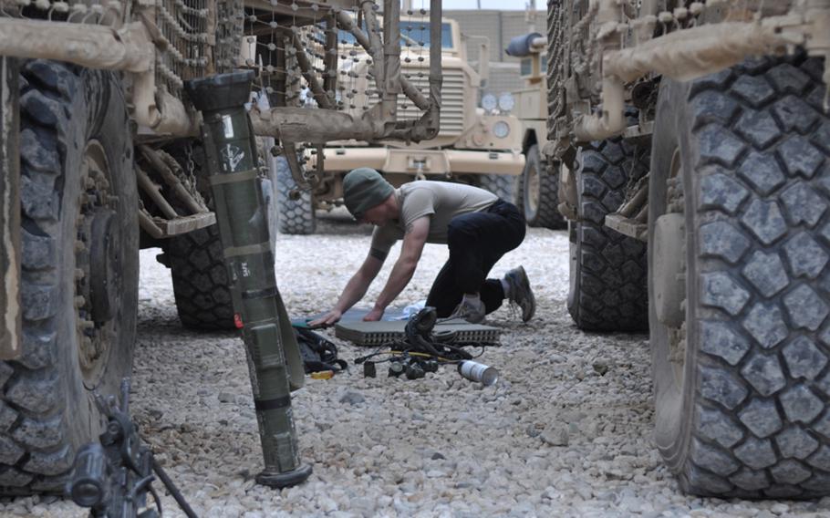 A soldier from Charlie Battery, 1-84 Field Artillery Battalion, cleans equipment during a maintenance day at COP Gormach in western Faryab province. Long before the Americans arrived, Soviet troops occupied the spot. Before the Soviets, British soldiers camped there, U.S. commanders said.