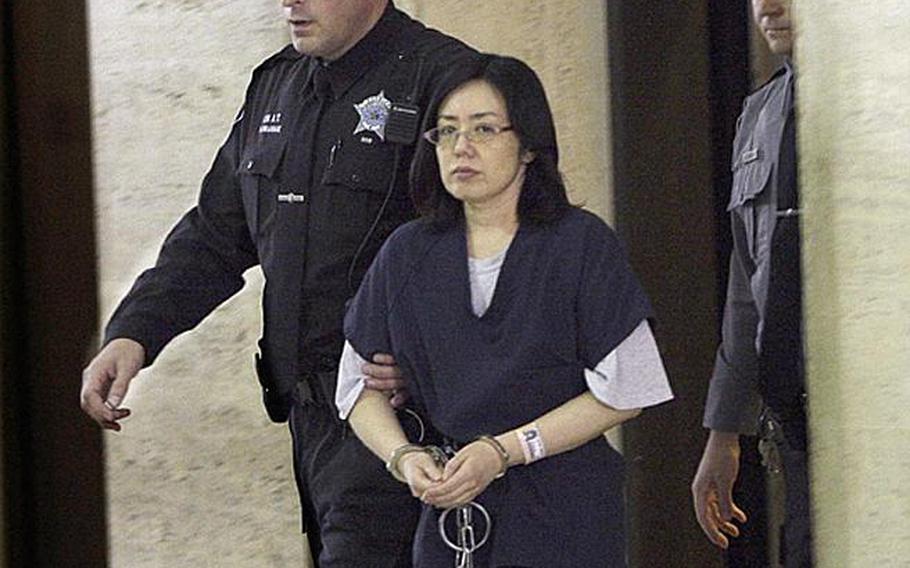 Emiko Inoue, the 43-year-old Japanese woman charged with unlawfully taking her daughter to Japan in 2008, a violation of U.S. custody orders, is escorted into a Milwaukee County court on Nov. 21, 2011. Inoue made a plea deal that will let her be released from jail if her daughter is returned to the States where her father lives.