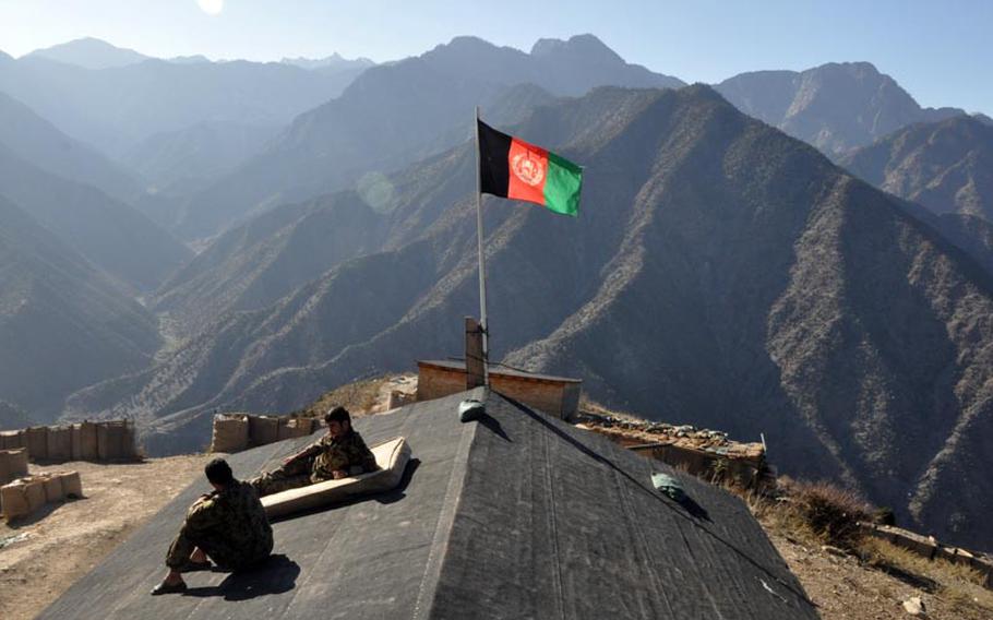 Afghan soldiers relax on the roof of a building at Observation Point Mace in northern Kunar province near the Pakistan border. The U.S. military turned over the outpost to the Afghan army last year.