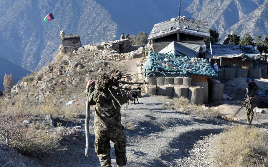 Afghan soldiers at Observation Point Mace in northern Kunar province gather wood each day to build fires for warmth and cooking. The outpost sits at almost 6,000 feet above sea level in the Hindu Kush mountains.