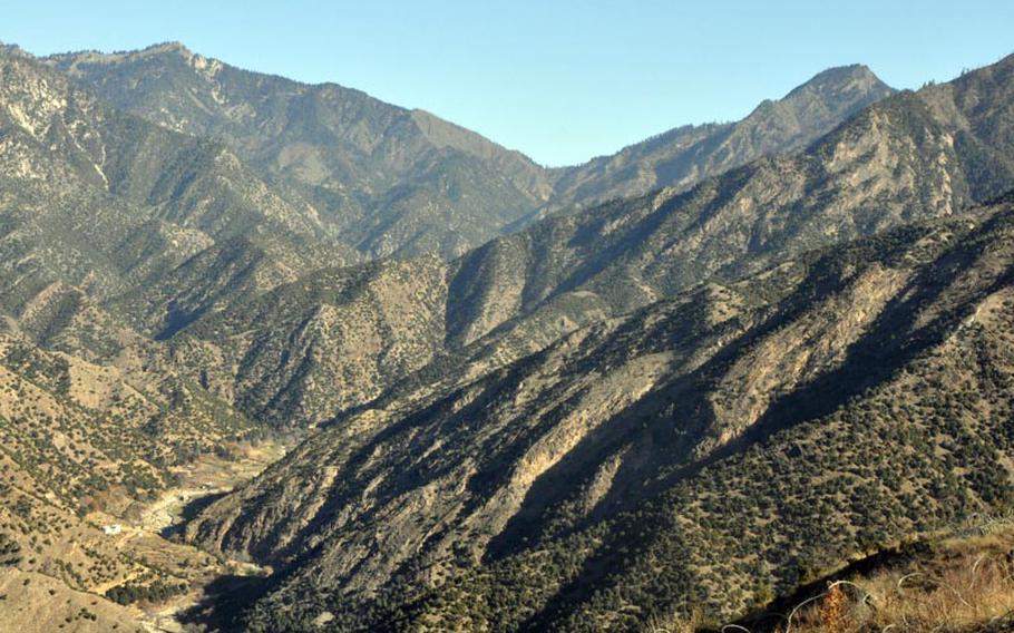 Observation Point Mace in Kunar province stands two miles from a low mountain pass, shown at the middle of this photo in the distance, used by insurgents to enter Afghanistan from Pakistan, which lies on the other side.