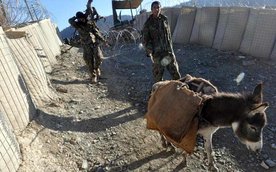 Afghan soldiers use donkeys to ferry supplies to Observation Point Mace from the valley floor a mile below in northern Kunar province.