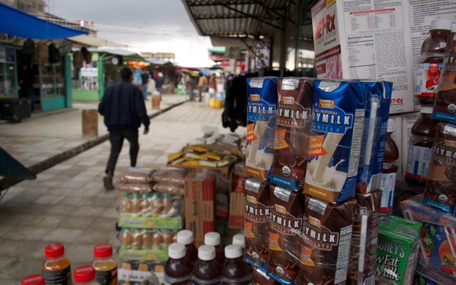 Stacks of American products, including Ocean Spray cranberry juice, Sunrich soy milk and Met-Rx nutritional supplements are stacked outside a shop stall in Kabul’s “Bush Market,” which specializes in goods apparently stolen from American supply convoys.