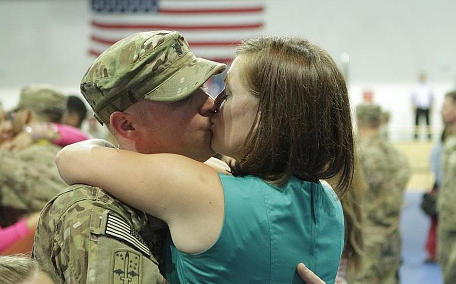 Liz Foster welcomes her husband, Spc. Jeff Foster, during a return ceremony Friday for members of the 172nd Separate Infantry Brigade in Grafenwoehr, Germany. Several hundred soldiers returned to both Grafenwoehr and Schweinfurt, as the brigade ends a 12-month tour in Afghanistan.