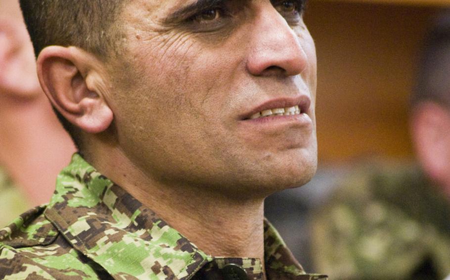Afghan Sgt. Maj. of the Army Roshan Safi listens to a speaker during a ceremony in his honor at Kabul Military Training Center on Jan. 18, 2011.