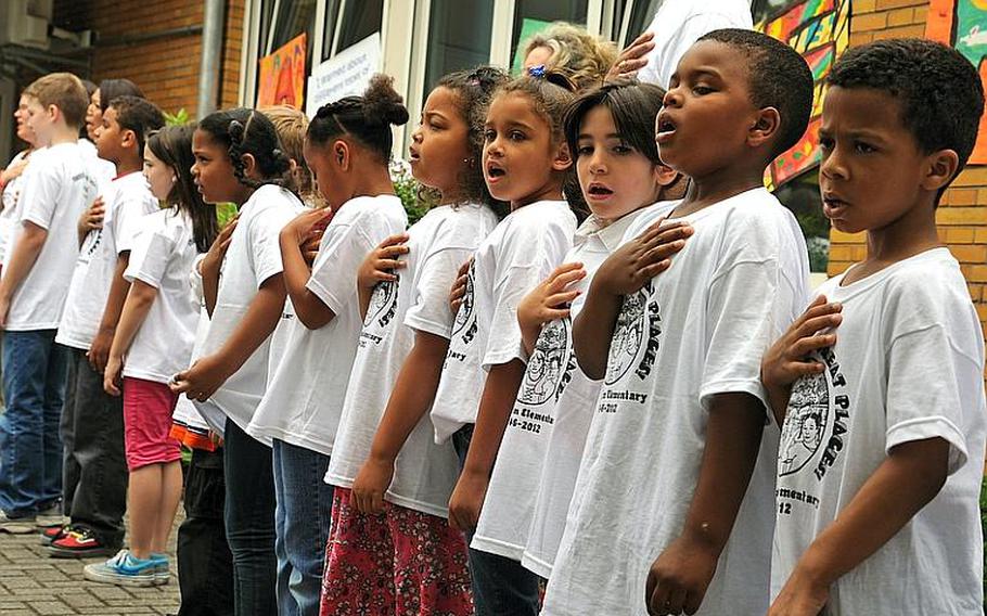 Mannheim Elementary School students sing the national anthem at the beginning of the school&#39;s closing ceremony Friday in Mannheim, Germany. The Mannheim Military Community is closing as a result of the realignment of U.S. forces in Europe.