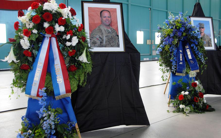 Photos of Chief Warrant Officer 5 John C. Pratt and Capt. John "Jay" Brainard are displayed at a memorial service Tuesday in Ansbach, Germany. The two 12th Combat Aviation Brigade soldiers were killed in a helicopter crash in Afghanistan on May 28.