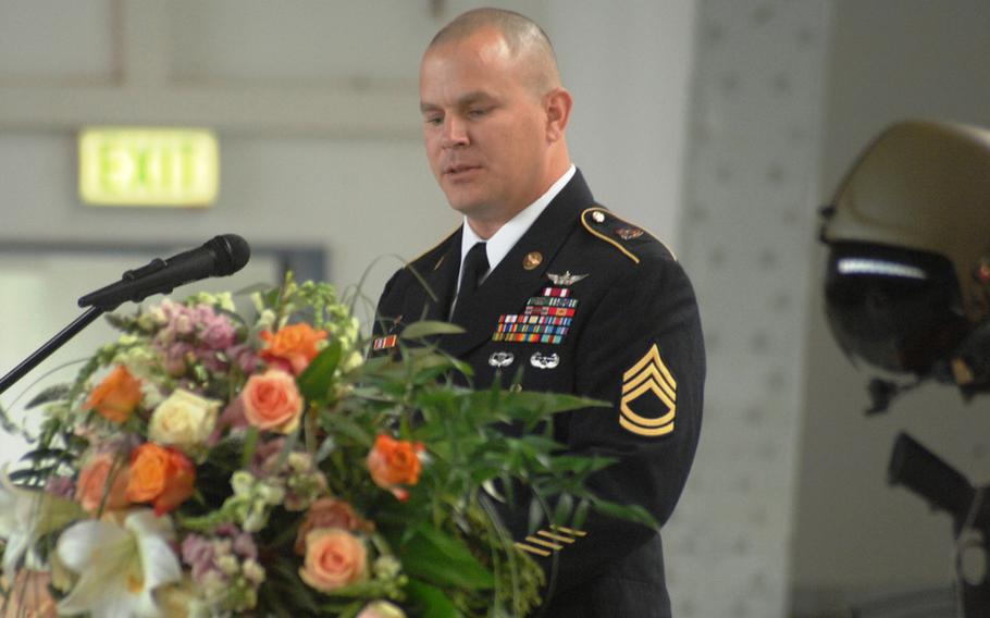 Sgt. 1st Class Todd Twiggs speaks at a memorial service Tuesday for Capt. John "Jay" Brainard, 26, and Chief Warrant Officer 5 John C. Pratt, 51, in Ansbach, Germany.