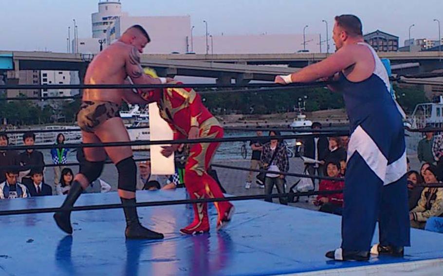 Sgt. Gaylon Summers, left, a Marine Aviation Logistics Squadron 12 ground safety manager stationed at Marine Corps Air Station Iwakuni, grapples with Azteca at an outdoor match in Fukuoka, Japan, on May 4. Summers will pursue his dream of being a professional wrestler when  he begins training in New Japan Pro-Wrestling&#39;s dojo in August.

Photo Courtesy of Gaylon Summers