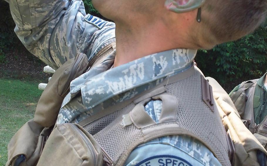 Air Force Survival, Evasion, Resistance and Escape specialist Staff Sgt. Robert Rogers eats an ant during training at Tama Hills Recreation Area. Since September 2001, SERE specialists have taught survival skills to more than 200,000 personnel.