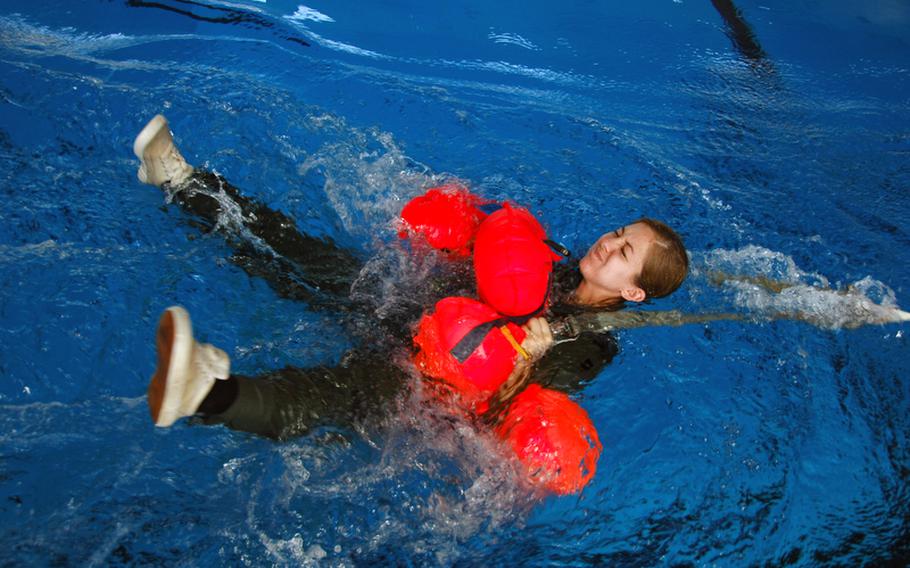 C-130 pilot Capt. Chrystina Jones, 27, of Wichita, Kan., is dragged through the water by her parachute harness during water survival training at Yokota Air Base, Japan, in April.
