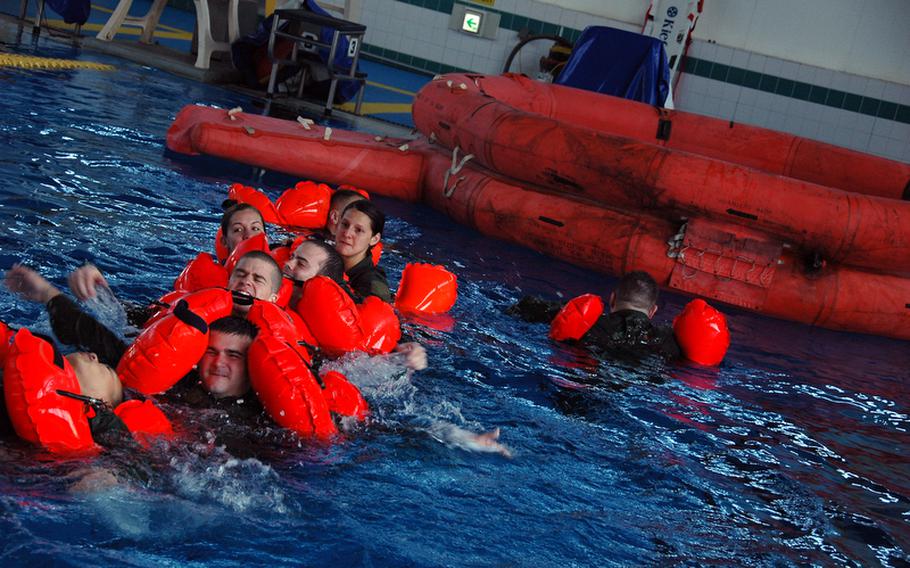 Members of the 374th Airlift Wing swim toward a rubber raft during water survival training at Yokota Air Base, Japan, in April. Advances in technology mean the U.S. military should be able to reach downed aircrews within a couple of hours off the coast of Japan.