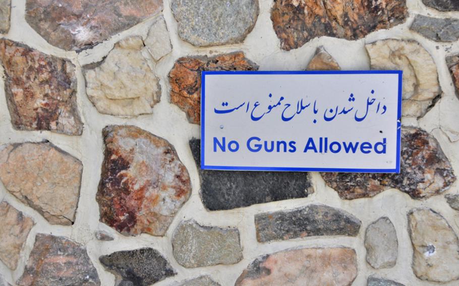 A sign outside a restaurant at a lakeside resort in Kabul where five armed militants staged a 12-hour attack that ended Friday morning. Eighteen people were killed in the ambush, including 14 civilians.