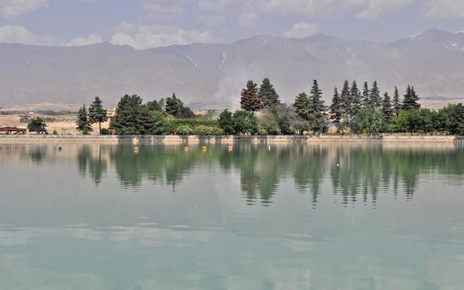 White smoke rises from a lakeside resort on the outskirts of Kabul, where militants launched an attack late Thursday that killed 18 people, including 14 civilians. Afghan security forces killed the five insurgents involved in the 12-hour siege.