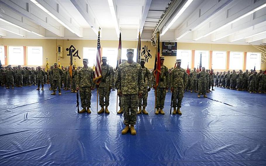 Soldiers of the 170th Infantry Brigade Combat Team stand motionless during their unit&#39;s change-of-command ceremony Tuesday inside the Hall of Champions at Smith Barracks, Baumholder, Germany.