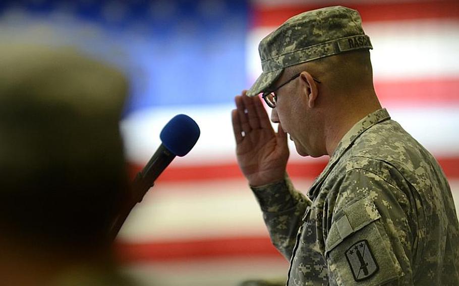 U.S. Army Col. Mark Raschke, incoming commander of the170th Infantry Brigade Combat Team, salutes his unit as he formally takes command during a ceremony Tuesday at Smith Barracks in Baumholder, Germany.